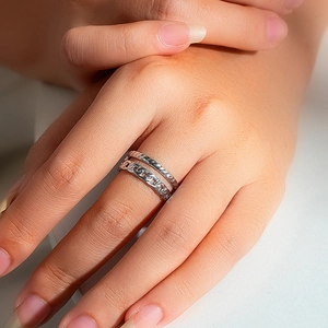Detail of silver double-layered ring with twisted rope and curb chain textures on a model