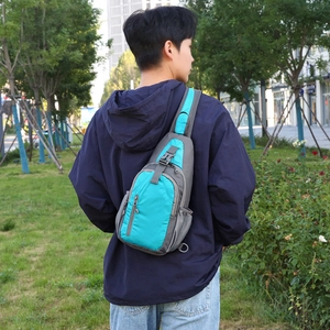 Waterproof nylon crossbody sling bag in teal and grey for outdoor sports and commuting