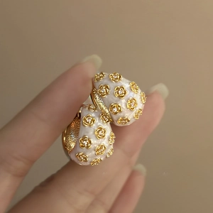 Vintage floral C-shaped earrings with white enamel and sparkling inlaid rhinestones