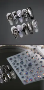 Macro shot of 3D gothic nail art stickers and press-on nails with marble texture