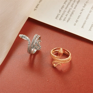 Retro gold and silver coiled snake rings with textured scales in a vintage aesthetic