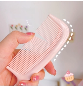 Close-up of pink hairbrush with rounded tips for scalp protection and massage
