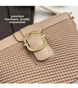 Close-up of pink woven texture underarm bag with minimalist round gold hardware detail