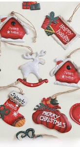 Close-up of vintage metal Christmas ornaments featuring reindeer and stocking designs