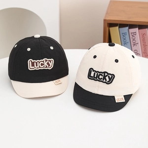 Detailed close-up of quick-dry kids baseball caps with Lucky embroidery and brand labels