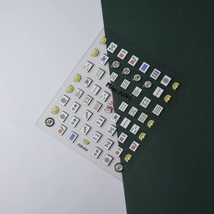 Close-up of 5D mahjong nail art stickers with embossed texture and gold fortune cats