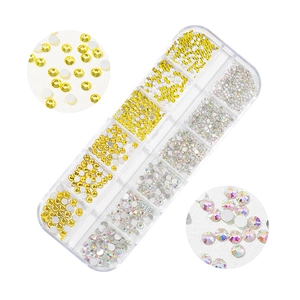 Macro detail of 12-grid nail art crystal set featuring yellow and AB clear glass rhinestones