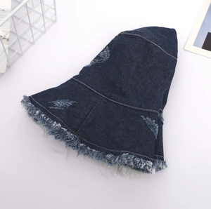 Chapeau bob en jean bleu foncé avec détails déchirés sur fond blanc pur