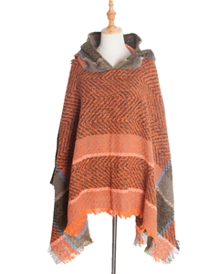 Women hooded knit poncho with orange herringbone pattern and tassel trim detail