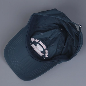 Detail of internal sweatband and adjustable metal buckle on quick-dry nylon baseball cap