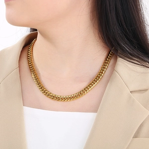 Golden curb chain necklace for men in hip-hop style worn by a model on plain background