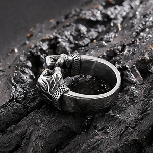 Macro shot of retro stainless steel ring with double fist relief and oxidized details