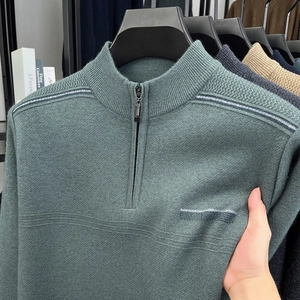 Close-up of men's half-zip knit sweater with stand collar and grey striped details