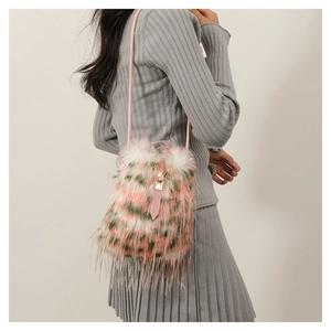 Detail view of colorful faux fur crossbody bag in pink, green and white on a model