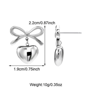 Detailed size view of silver bow and heart pendant earrings with dimension markings