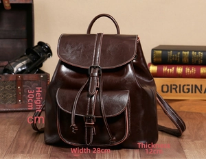 Detailed view of a vintage dark brown oil-wax leather backpack with size 30x28x12cm