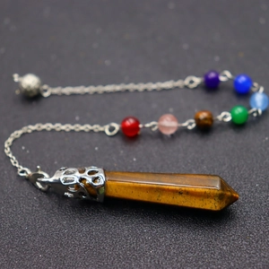 Detail of tiger eye hexagonal stone pendant with silver carved cap and seven chakra beads