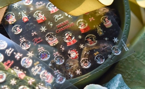 Detail of 5D embossed Christmas nail stickers with Santa Claus and reindeer designs