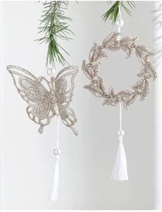 Detail of champagne gold glitter butterfly ornament with white tassels and pearls