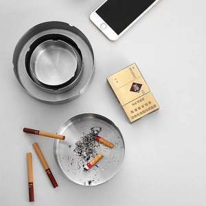 Three sizes of durable brushed golden stainless steel ashtrays on a gray surface