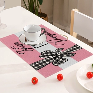 Close-up of pink autumn placemat with white stripes, farmhouse bow, and pumpkin script