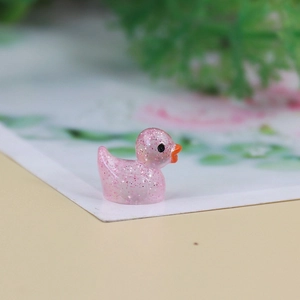 Macro side view of a pink translucent resin duckling with glitter for DIY micro landscapes