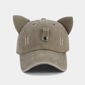 Close-up of olive brown washed cotton baseball cap with 3D cat ears and metal button detail