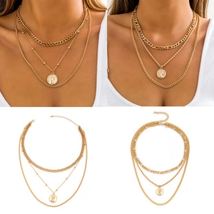 Detail view of gold layered necklaces with coin pendants on a model and flat lay