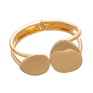 Minimalist golden irregular geometric double-layered open bangle with a polished metallic finish