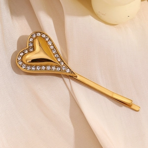 Vintage 18K gold plated heart hair clip with diamonds on beige silk backdrop