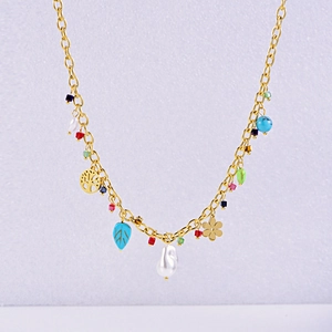 Detail of gold chain necklace with colorful beads, baroque pearls and tree of life charms