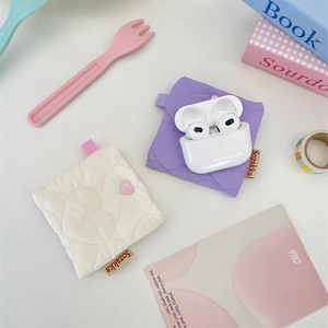 Macro detail of quilted heart pattern on lavender and cream mini soft shell earphone cases