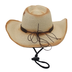 Detail of vintage straw cowboy hat with gradient brim and adjustable windproof strap