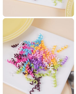Colorful spiral elastic hair ties in macaron colors displayed on a white dish