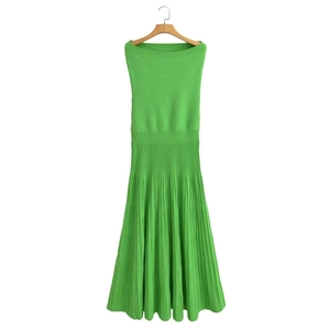 Detailed texture of green knitted strapless dress with ribbed bodice and pleated hemline