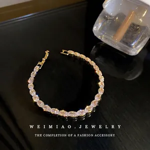 Elegant gold-tone link bracelet with multiple oval-cut clear cubic zirconia stones