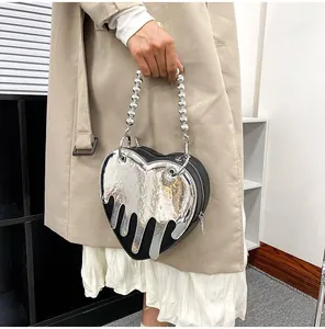 Detail of heart-shaped bag with liquid metal melt effect and silver bead handle strap