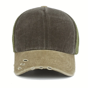 Detailed view of vintage washed trucker hat with distressed khaki brim and green mesh back