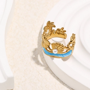 Detailed close-up of 18K gold plated starfish shell ring with pearl and blue enamel