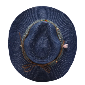 Close-up of navy woven straw hat featuring colorful beads and pink tassel detail