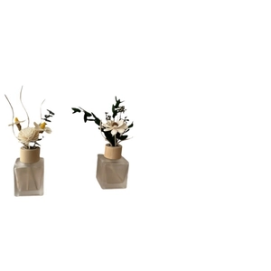 Frosted glass reed diffuser set with dry flowers and natural wooden lids for home fragrance