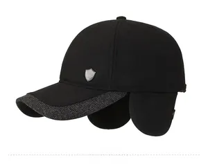 Detail view of winter wool baseball cap with foldable ear flaps and metal emblem