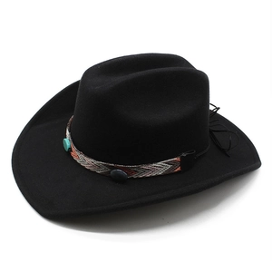 Detail of black felt cowboy hat with ethnic woven band and turquoise bead decoration