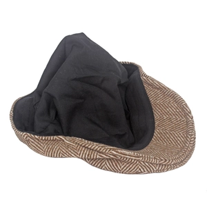 Detailed view of the herringbone wool blend fabric and black lining on a newsboy flat cap