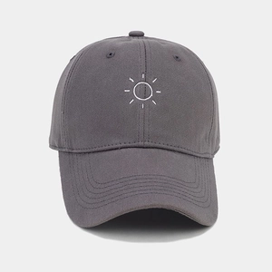 Close-up of a grey cotton baseball cap with white sun embroidery and curved brim detail