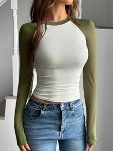 Dettaglio di una maglietta a maniche lunghe slim fit con maniche raglan verde oliva e corpo bianco
