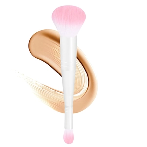 Dual-head makeup brush with pink bristles and white handle on cosmetic background