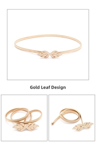 Detailed close-up of golden leaf buckle and elastic metallic weave belt for women