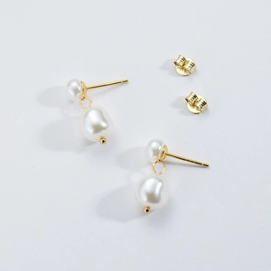 Detailed view of S925 sterling silver baroque pearl earrings with gold-plated pins