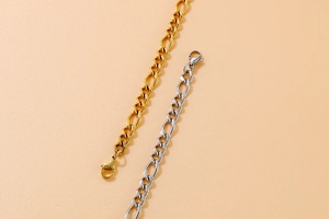 Close-up of gold and silver Figaro link jewelry chains in a professional layout
